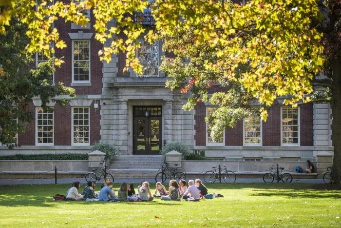 Students sitting on the lawn in front of Seelye Hall.
